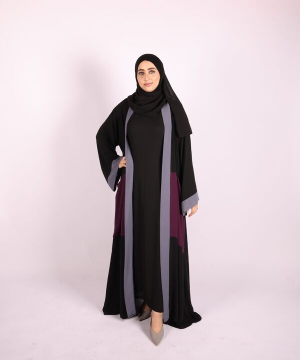 A two-piece abaya in black with subtle accents in gray and berry